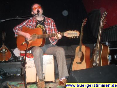 Pressefoto: http://www.buergerstimmen.de/ , 2011 &copy; Neben dem Gitarrenspiel begleitete Stoppok seinen Gesang mit Perkussion (Cajon, ..)